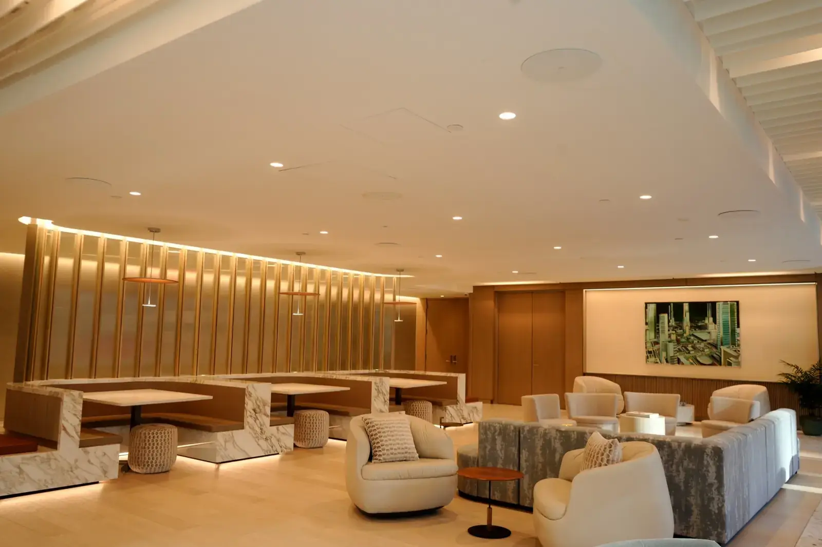 Building amenity lounge with in-ceiling speakers and warm lighting