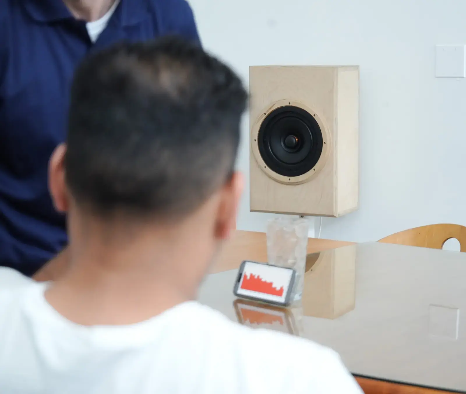 Engineer measuring a loudspeaker with an analyzer app