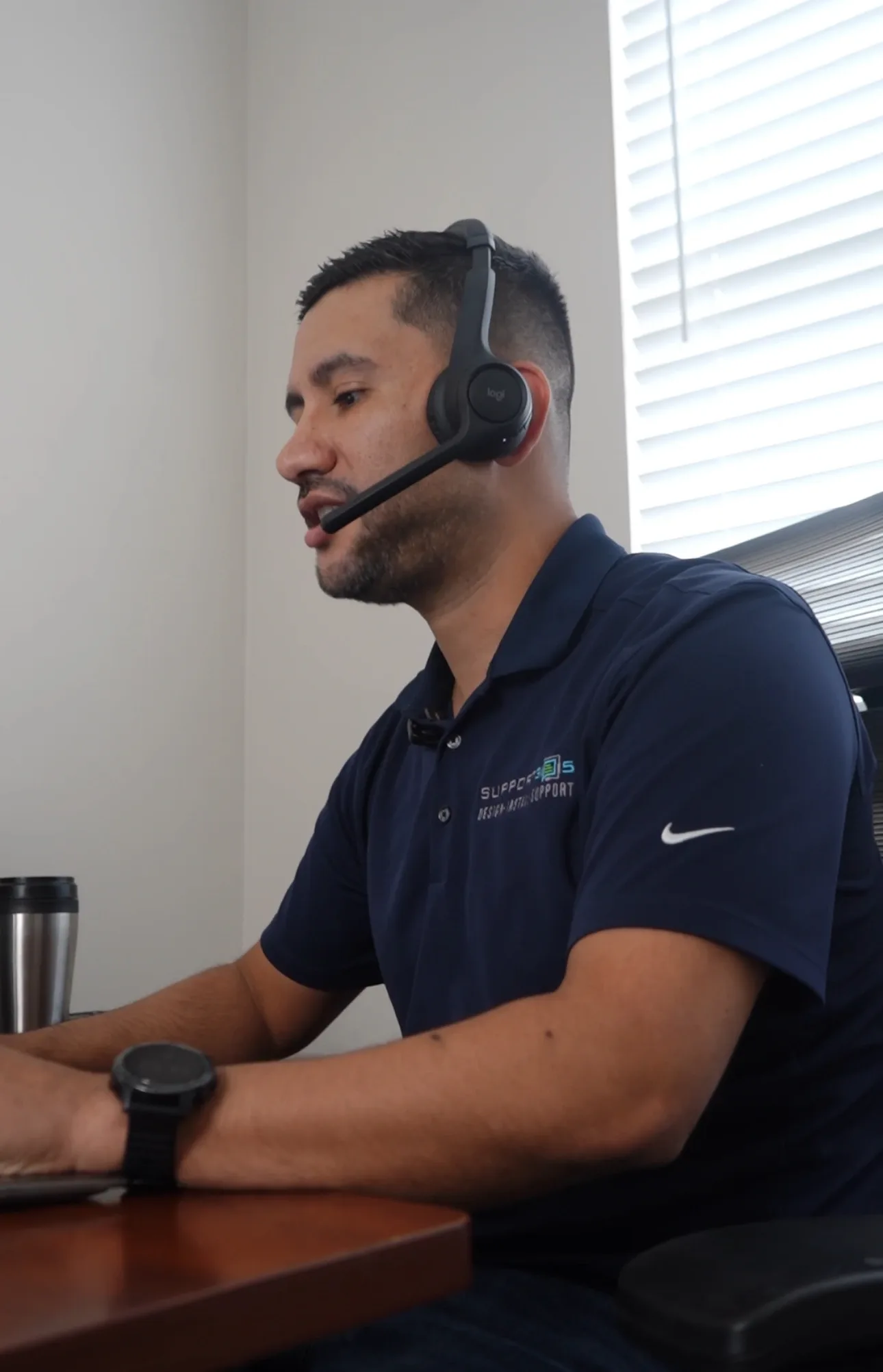 DIST help desk engineer on a headset supporting a client