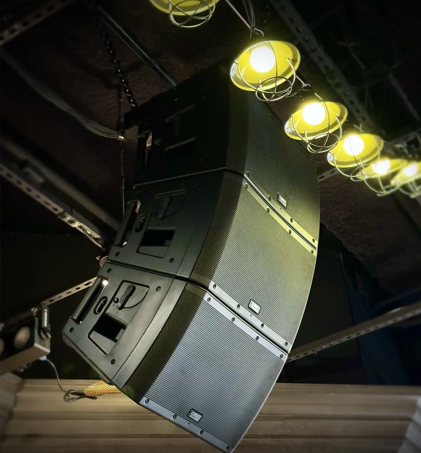 Line-array loudspeaker cabinets rigged overhead