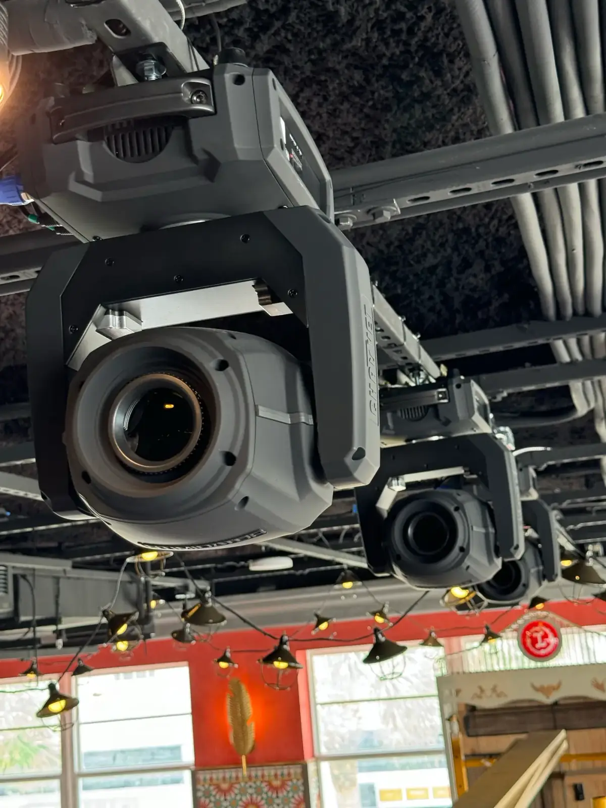 Moving-head lighting fixtures rigged in a venue