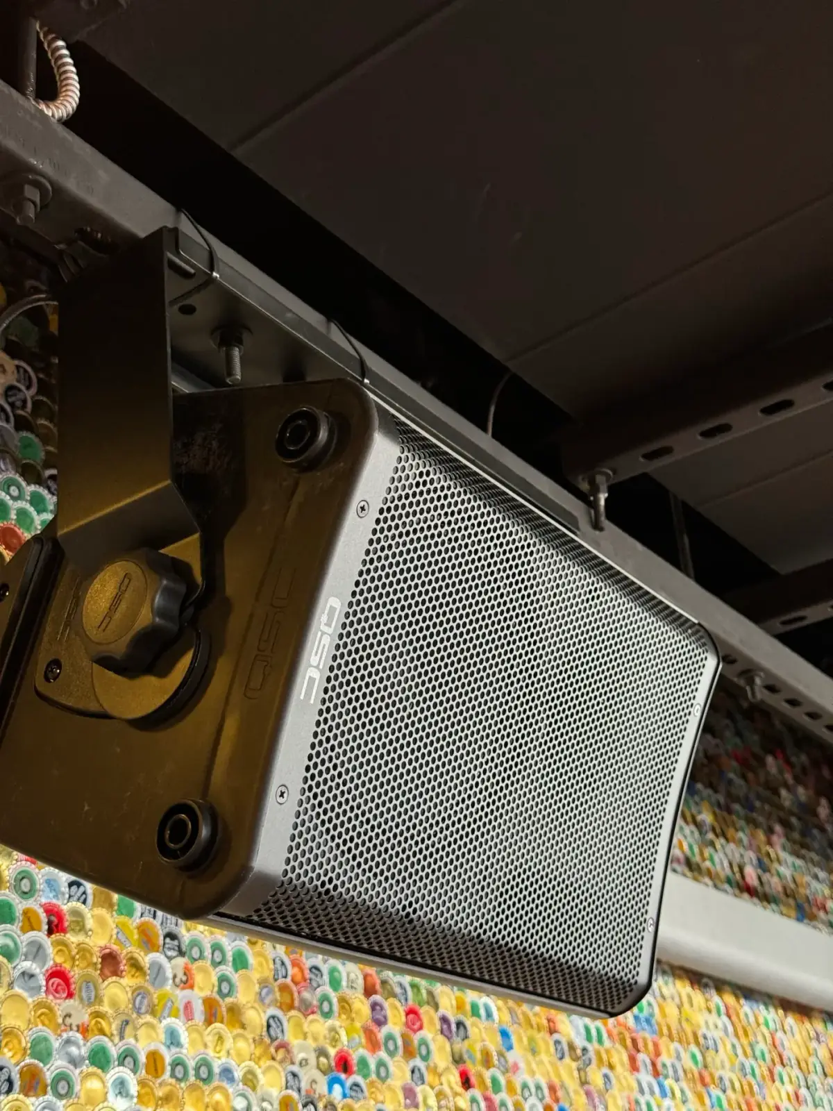 QSC loudspeaker mounted overhead in a venue