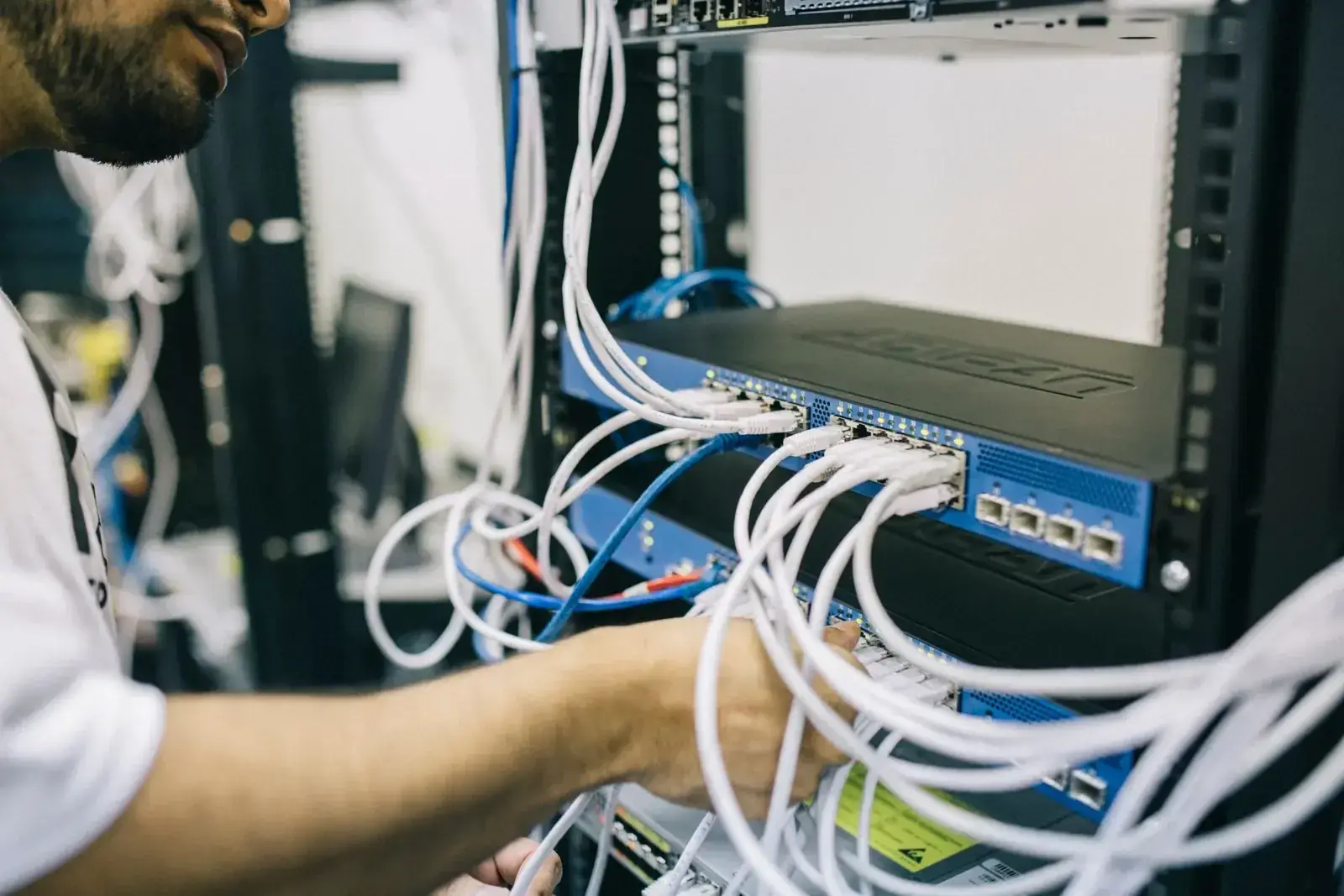 DIST technician patching a backup and network rack