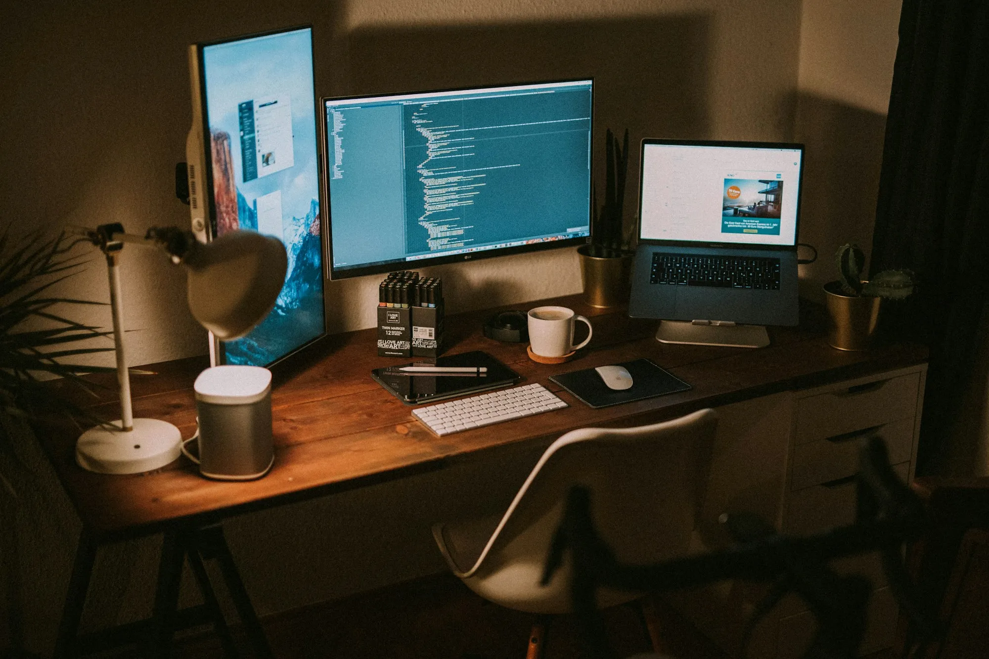 Workstation with monitors and a laptop set up and ready to use